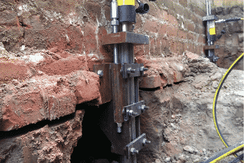 hydraulic slab lift piers installed on a brick foundation