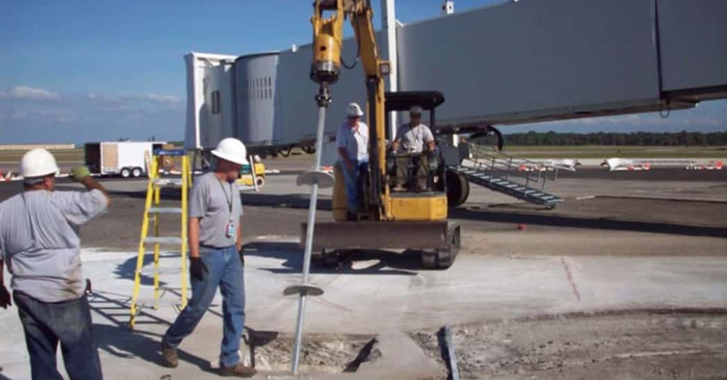 helical piers install at an airport