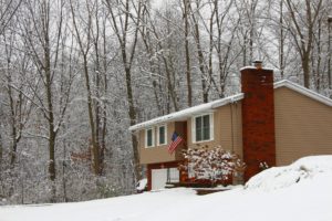 Snow covered home in woods