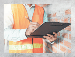 Foundation inspector writing on clipboard during a foundation inspection quote.
